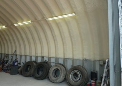 Photo of sprayfoam insulation installed to a pre-fab metal arch building by Isotech
