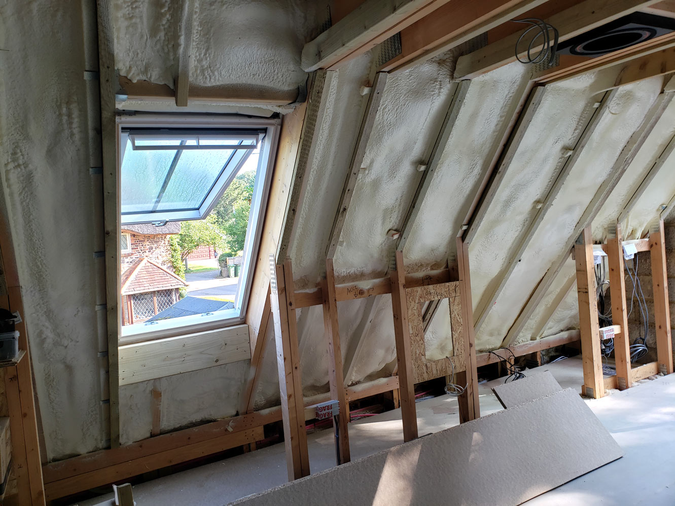 Annexe roof insulation showing foam applied around Velux window